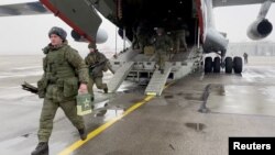 Russian armed service members, part of a Collective Security Treaty Organization peacekeeping mission, arrive in Kazakhstan on January 7, 2022. 