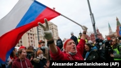A supporter waves a Russian flag and shouts slogans during the April 21, 2021 rally in Moscow in support of jailed opposition leader Aleksei Navalny..